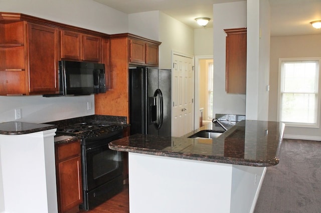 45862 S Stonewood Rd Unit 218, Canton, MI 48187 - kitchen with black appliances, a sink, dark stone countertops, a peninsula, and open shelves