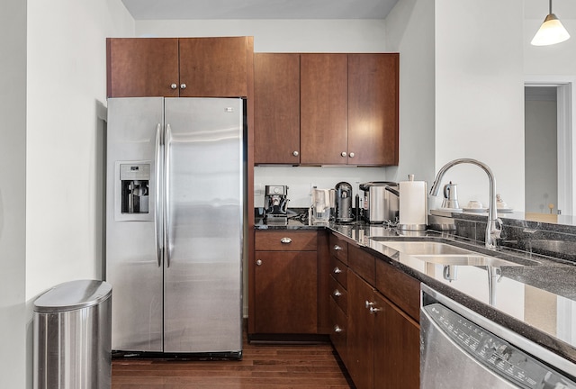 1135 Shelby St Unit 59-2808, Detroit, MI 48226 - kitchen with stainless steel appliances, a sink, dark wood-type flooring, dark stone countertops, and pendant lighting