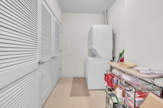 1135 Shelby St Unit 59-2808, Detroit, MI 48226 - laundry room featuring stacked washing machine and dryer, light floors, and baseboards