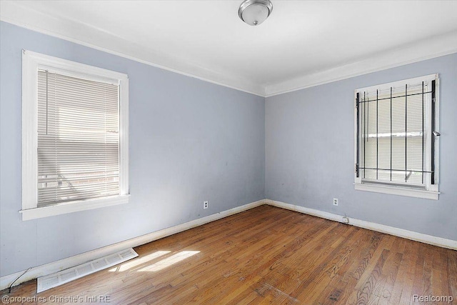19479 Helen St, Detroit, MI 48234 - empty room with wood finished floors, baseboards, and crown molding