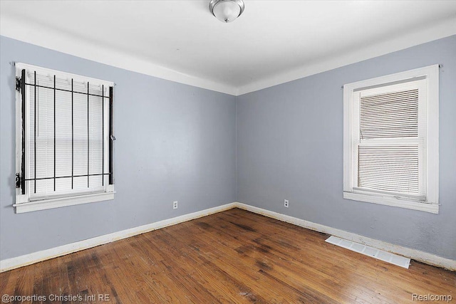 19479 Helen St, Detroit, MI 48234 - empty room featuring baseboards, wood finished floors, and healthy amount of natural light