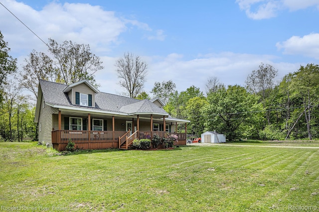 6621 Dove Rd, Kimball, MI 48074 - view of front facade with a porch, a front yard, a detached garage, and a shingled roof