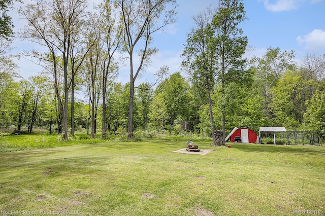 6621 Dove Rd, Kimball, MI 48074 - view of grassy yard with an outbuilding and a fire pit