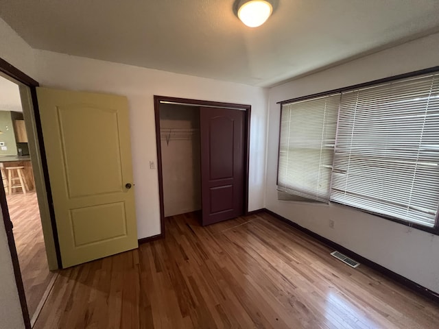 72 E Brink St, Grant, MI 49327 - unfurnished bedroom featuring a closet, wood finished floors, and baseboards