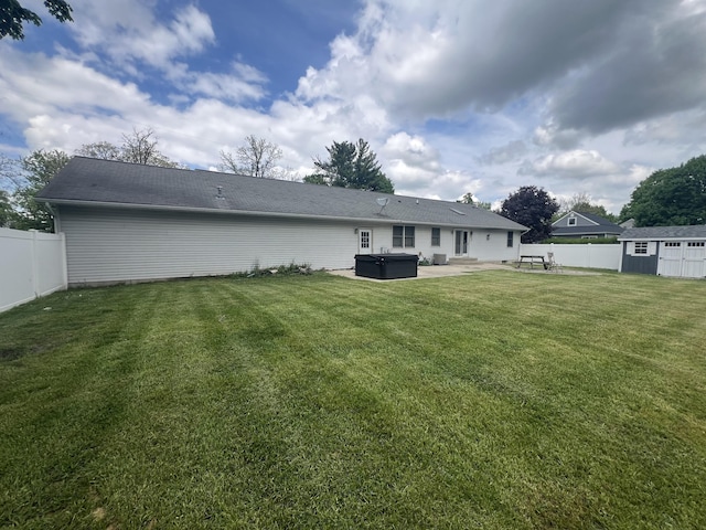 72 E Brink St, Grant, MI 49327 - rear view of house featuring a hot tub, a patio, an outbuilding, and a storage shed