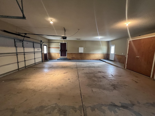 72 E Brink St, Grant, MI 49327 - garage with a garage door opener and a wainscoted wall