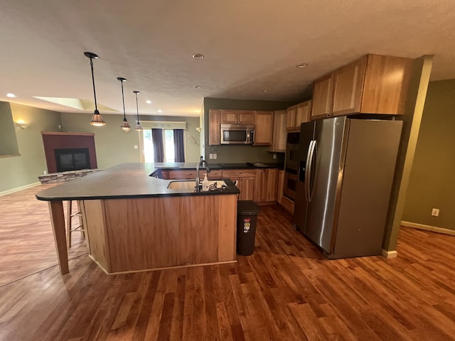 72 E Brink St, Grant, MI 49327 - kitchen with stainless steel appliances, dark countertops, dark wood-style flooring, and recessed lighting