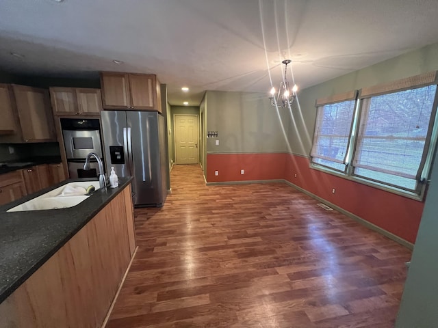 72 E Brink St, Grant, MI 49327 - kitchen with appliances with stainless steel finishes, a sink, baseboards, wood finished floors, and recessed lighting