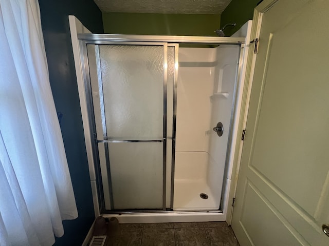72 E Brink St, Grant, MI 49327 - bathroom with a shower stall, a textured ceiling, and tile patterned flooring