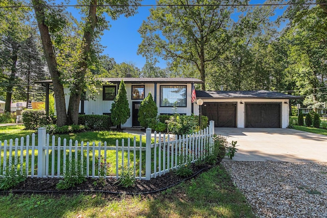 819 W Michigan St, New Buffalo, MI 49117 - view of front of home with an attached garage, driveway, and fence
