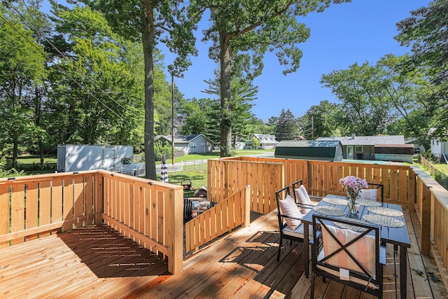 819 W Michigan St, New Buffalo, MI 49117 - deck with outdoor dining area and view of scattered trees