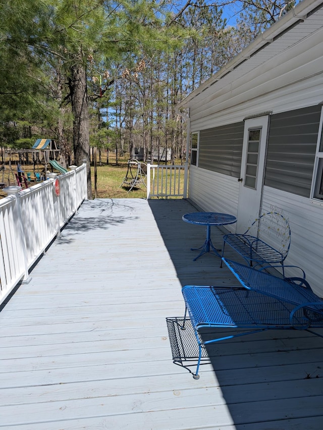 5268 S Arrowhead Trl, Baldwin, MI 49304 - wooden deck with a playground