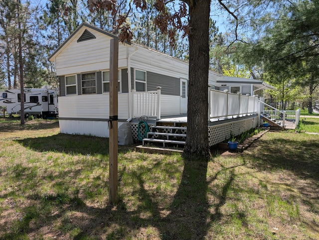 5268 S Arrowhead Trl, Baldwin, MI 49304 - view of side of property featuring a deck and a yard