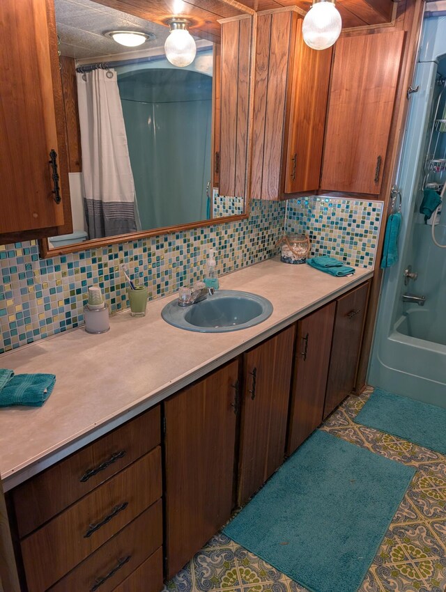 5268 S Arrowhead Trl, Baldwin, MI 49304 - full bath with decorative backsplash, vanity, and shower / tub combo with curtain