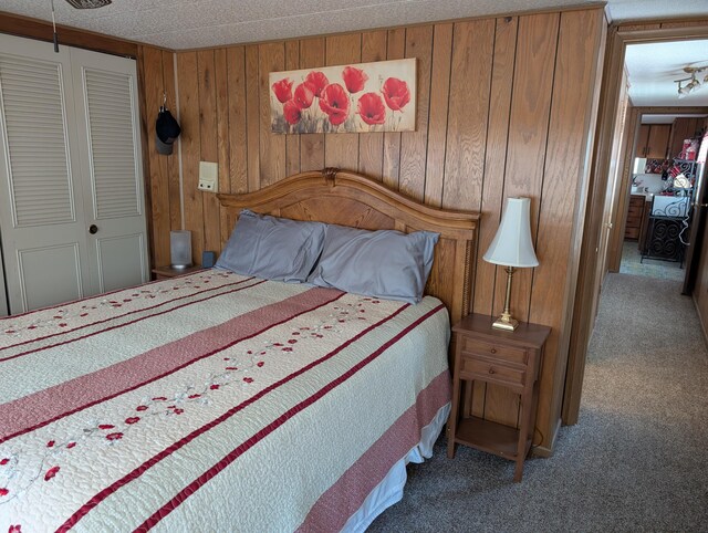 5268 S Arrowhead Trl, Baldwin, MI 49304 - bedroom with carpet, a closet, and wooden walls
