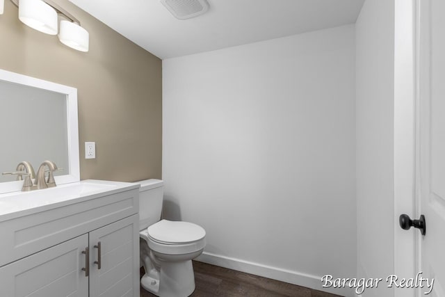 964 Lincoln Ave NW, Grand Rapids, MI 49504 - half bath featuring wood finished floors, vanity, toilet, and baseboards