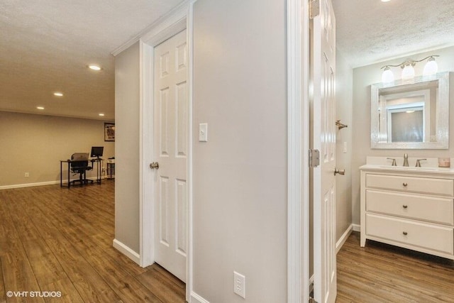2553 Bristol Ter, Saint Joseph, MI 49085 - corridor featuring baseboards, a desk, wood finished floors, a sink, and recessed lighting