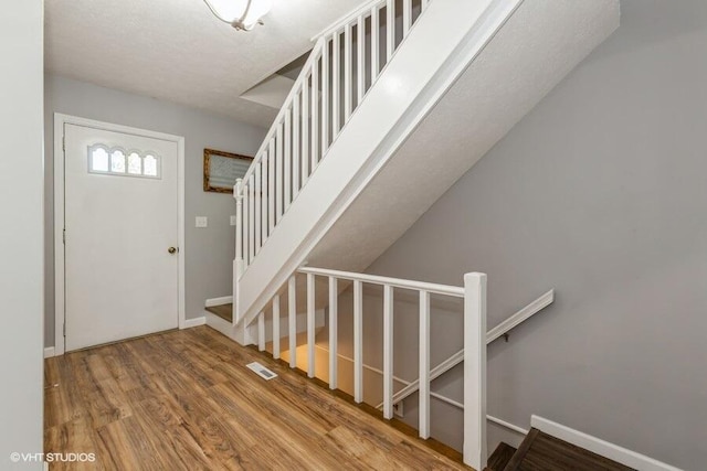 2553 Bristol Ter, Saint Joseph, MI 49085 - foyer with wood finished floors, stairs, and baseboards