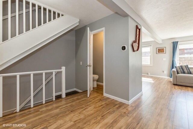 2553 Bristol Ter, Saint Joseph, MI 49085 - hallway with wood finished floors, a textured ceiling, and baseboards