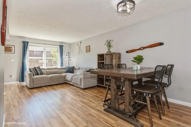 2553 Bristol Ter, Saint Joseph, MI 49085 - dining space with light wood finished floors, a textured ceiling, and baseboards