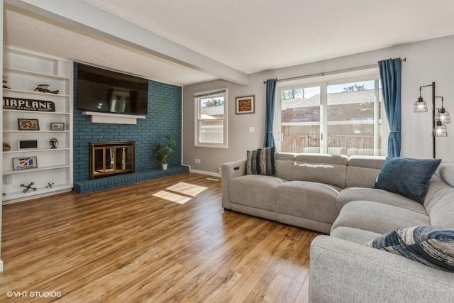 2553 Bristol Ter, Saint Joseph, MI 49085 - living area featuring wood finished floors, a fireplace, beam ceiling, and baseboards