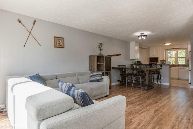 2553 Bristol Ter, Saint Joseph, MI 49085 - living area with light wood-style floors, a textured ceiling, and baseboards
