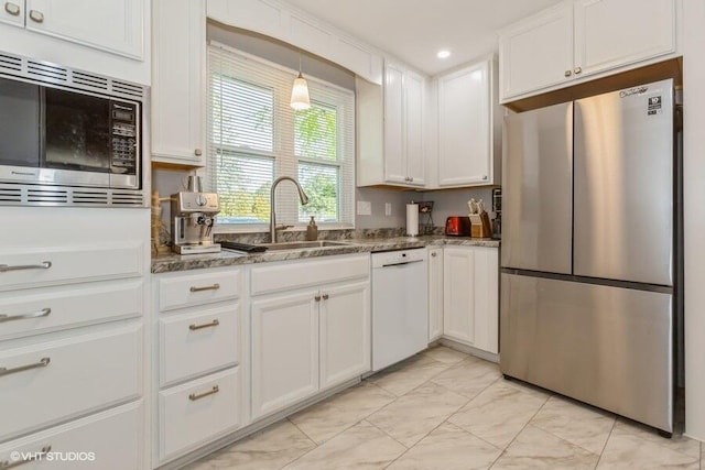 2553 Bristol Ter, Saint Joseph, MI 49085 - kitchen with stainless steel appliances, a sink, white cabinetry, dark stone counters, and recessed lighting