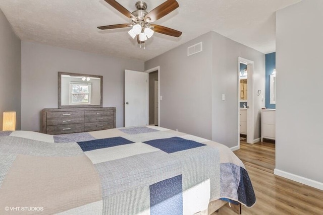 2553 Bristol Ter, Saint Joseph, MI 49085 - bedroom featuring wood finished floors, baseboards, ensuite bathroom, and a ceiling fan