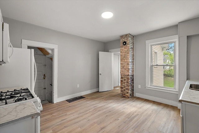 470 Houseman Ave NE, Grand Rapids, MI 49503 - kitchen featuring light countertops, baseboards, and light wood-style floors