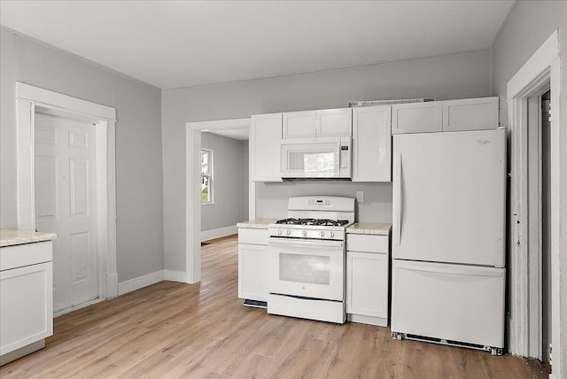 470 Houseman Ave NE, Grand Rapids, MI 49503 - kitchen with white appliances, light countertops, light wood-style floors, baseboards, and white cabinetry