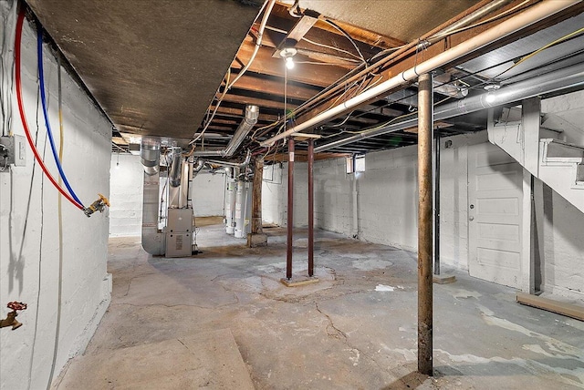 470 Houseman Ave NE, Grand Rapids, MI 49503 - unfinished below grade area featuring gas water heater, heating unit, and stairway