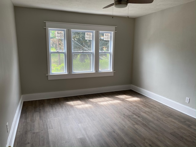 470 Houseman Ave NE, Grand Rapids, MI 49503 - unfurnished room with plenty of natural light, dark wood finished floors, a ceiling fan, baseboards, and a textured ceiling