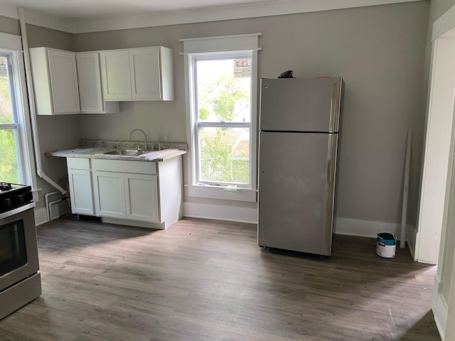 470 Houseman Ave NE, Grand Rapids, MI 49503 - kitchen featuring appliances with stainless steel finishes, a sink, white cabinetry, and dark wood-style flooring