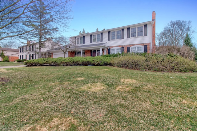 33951 Old Timber Rd, Farmington Hills, MI 48331 - traditional-style house with brick siding, a front yard, and a chimney
