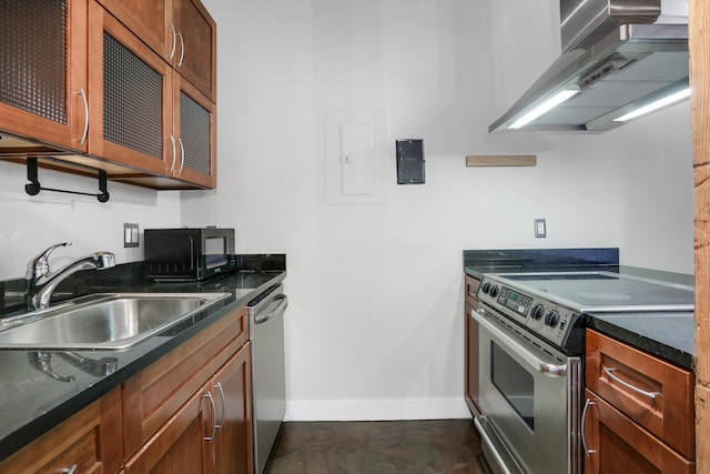 6533 E Jefferson Ave Unit 413W, Detroit, MI 48207 - kitchen with stainless steel appliances, a sink, baseboards, wall chimney exhaust hood, and glass insert cabinets