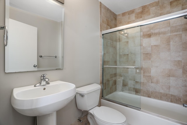 6533 E Jefferson Ave Unit 413W, Detroit, MI 48207 - bathroom featuring a sink, toilet, and combined bath / shower with glass door