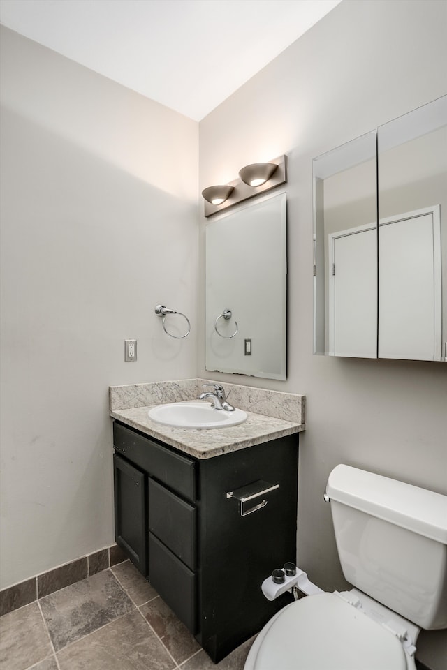 6533 E Jefferson Ave Unit 413W, Detroit, MI 48207 - bathroom featuring vanity, toilet, and stone finish flooring