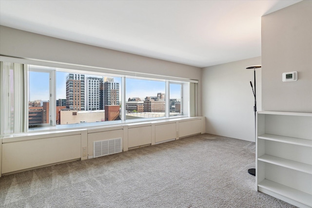 555 E William St Unit 10D, Ann Arbor, MI 48104 - spare room featuring light colored carpet and a city view