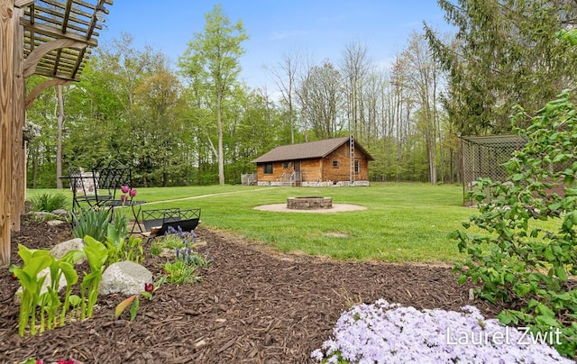 1442 W Tyler Rd, Hart, MI 49420 - view of green lawn featuring an outdoor fire pit and an outbuilding