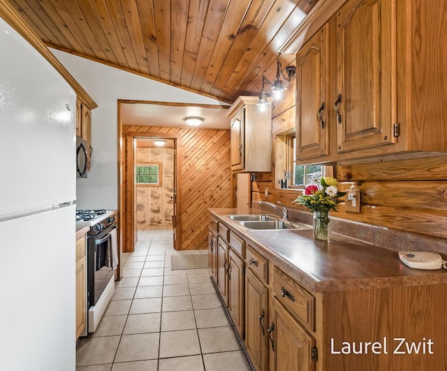 1442 W Tyler Rd, Hart, MI 49420 - kitchen featuring freestanding refrigerator, gas range, healthy amount of natural light, a sink, and vaulted ceiling