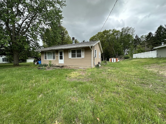 2330 Kint Ct, Jackson, MI 49202 - back of property with a shed, an outdoor structure, and fence