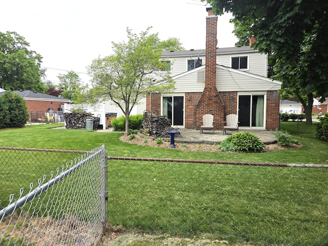 rear view of property featuring brick siding, a chimney, and a patio area