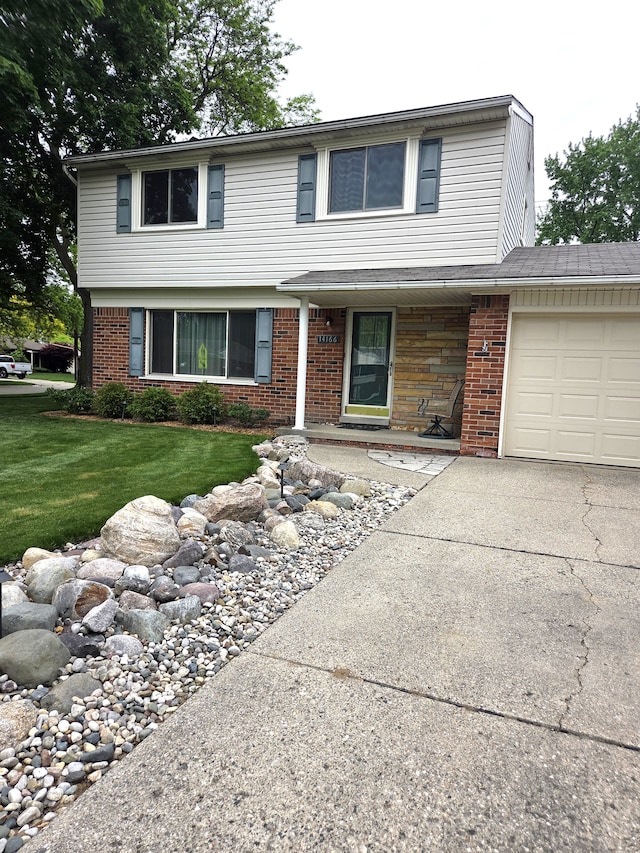 view of front facade featuring a garage, driveway, a front lawn, and brick siding