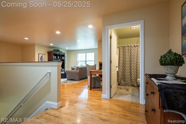 2038 Pine Bluffs Ct, Highland, MI 48357 - hallway with an upstairs landing, light wood finished floors, and recessed lighting