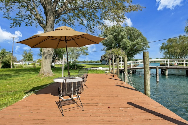 dock featuring a lawn and a water view