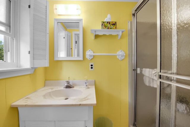 full bath with a stall shower and vanity