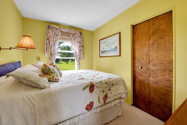 bedroom with carpet flooring and crown molding