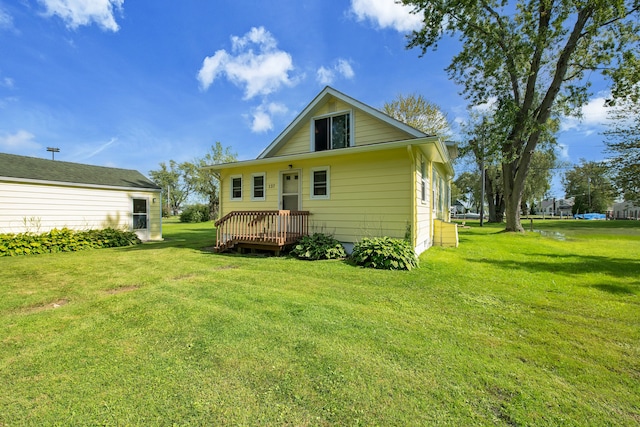 back of house with a lawn