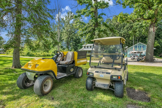 view of grassy yard with view of wooded area