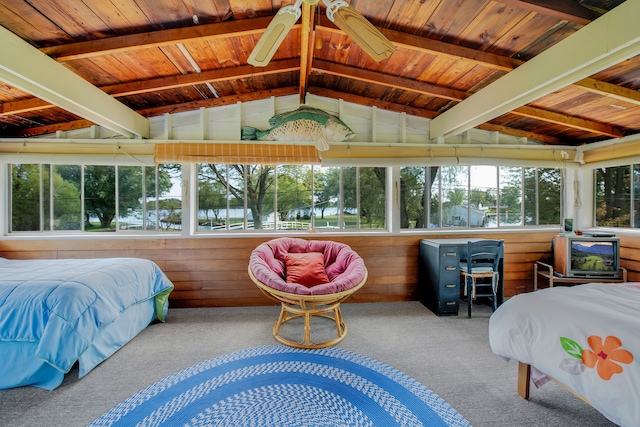 bedroom with carpet floors, wood ceiling, and wooden walls